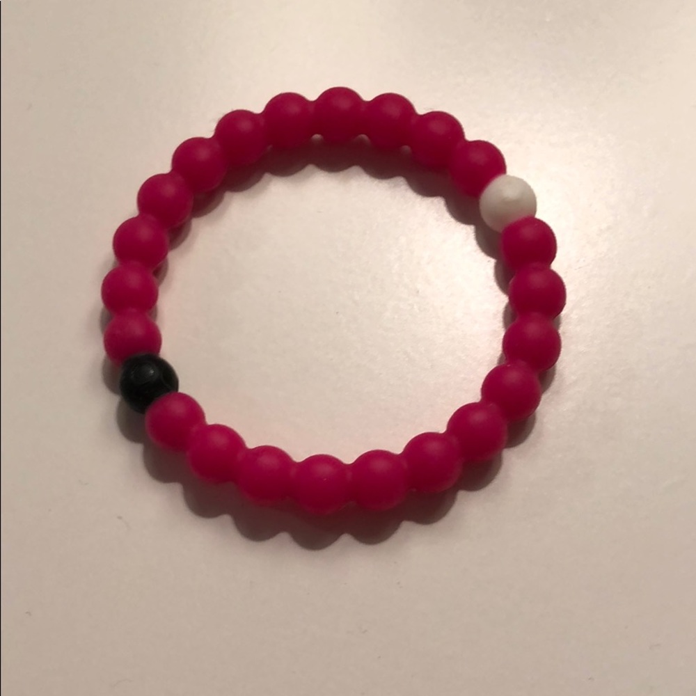 Pink lokai bracelet for breast cancer.